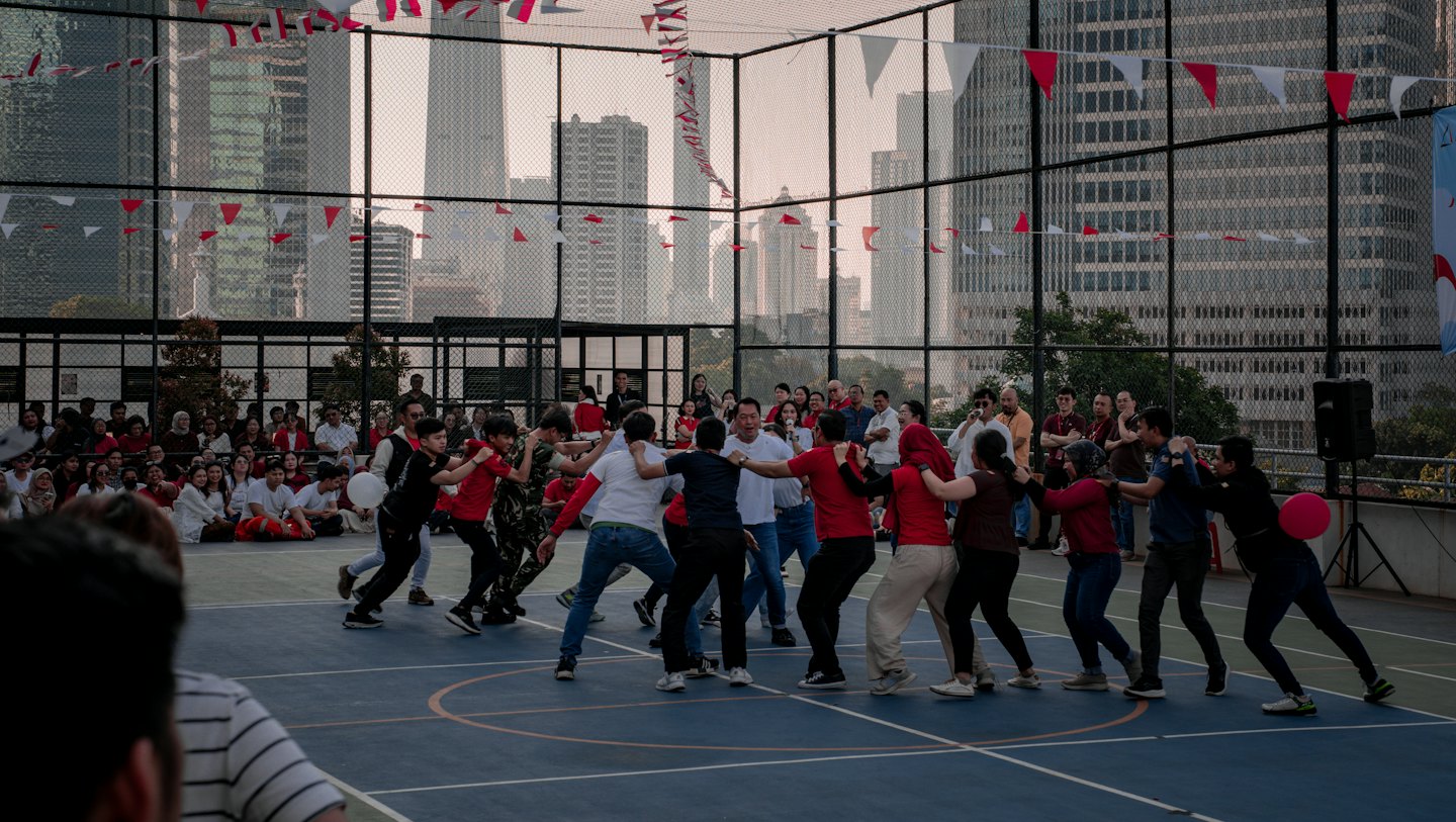 People play a team game on an outdoor urban court.
